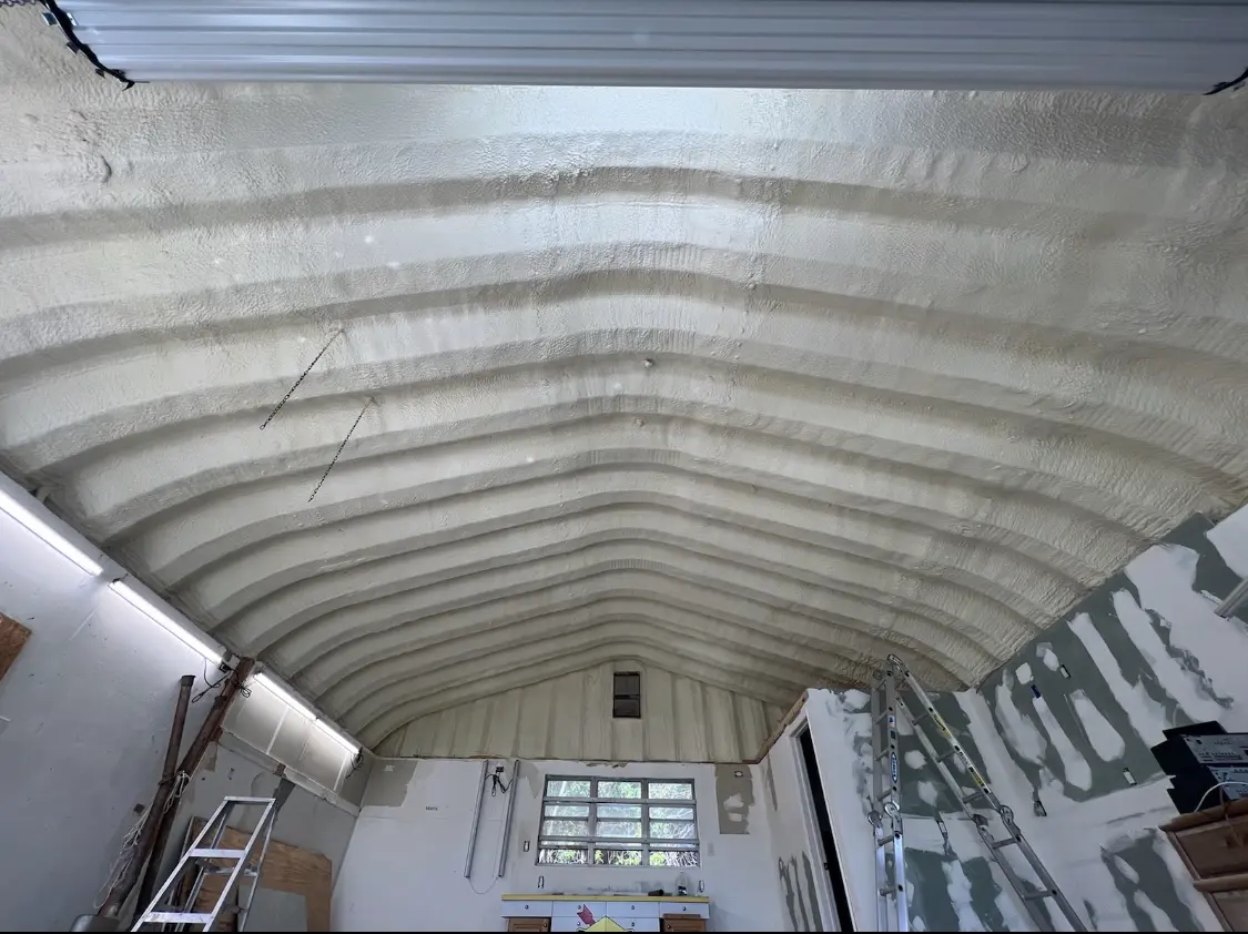 Spray polyurethane foam applied to the underside of a metal roof deck in University Heights